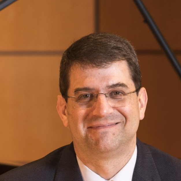 Environmental portrait of Peter Jutras in Ramsey Concert Hall. Headshot of Peter Jutras, PhD