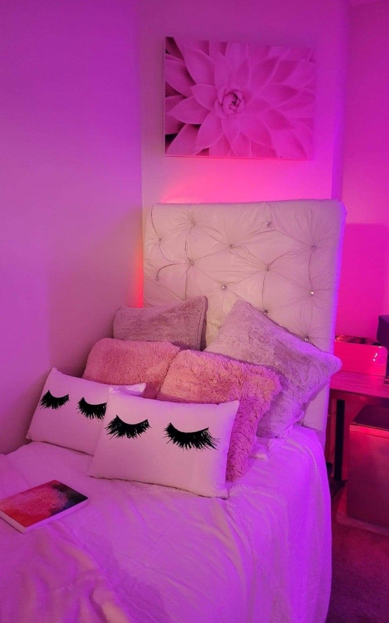 U Square doom room bed decorated with pink LED lights and decorative pillows
