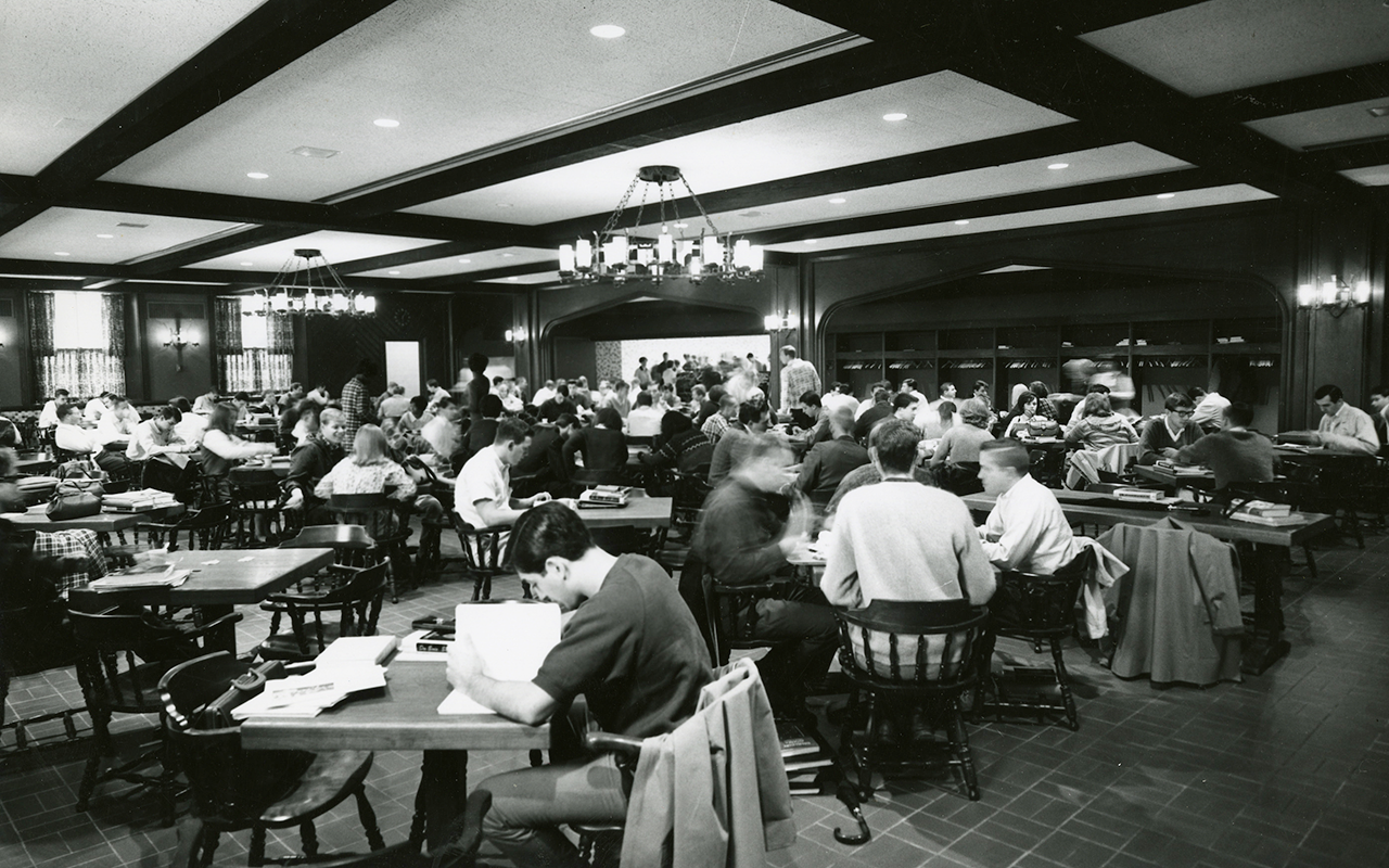 Dining room with students studying at tables for 4