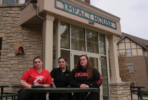 Gen-1 students standing in front of Impact House