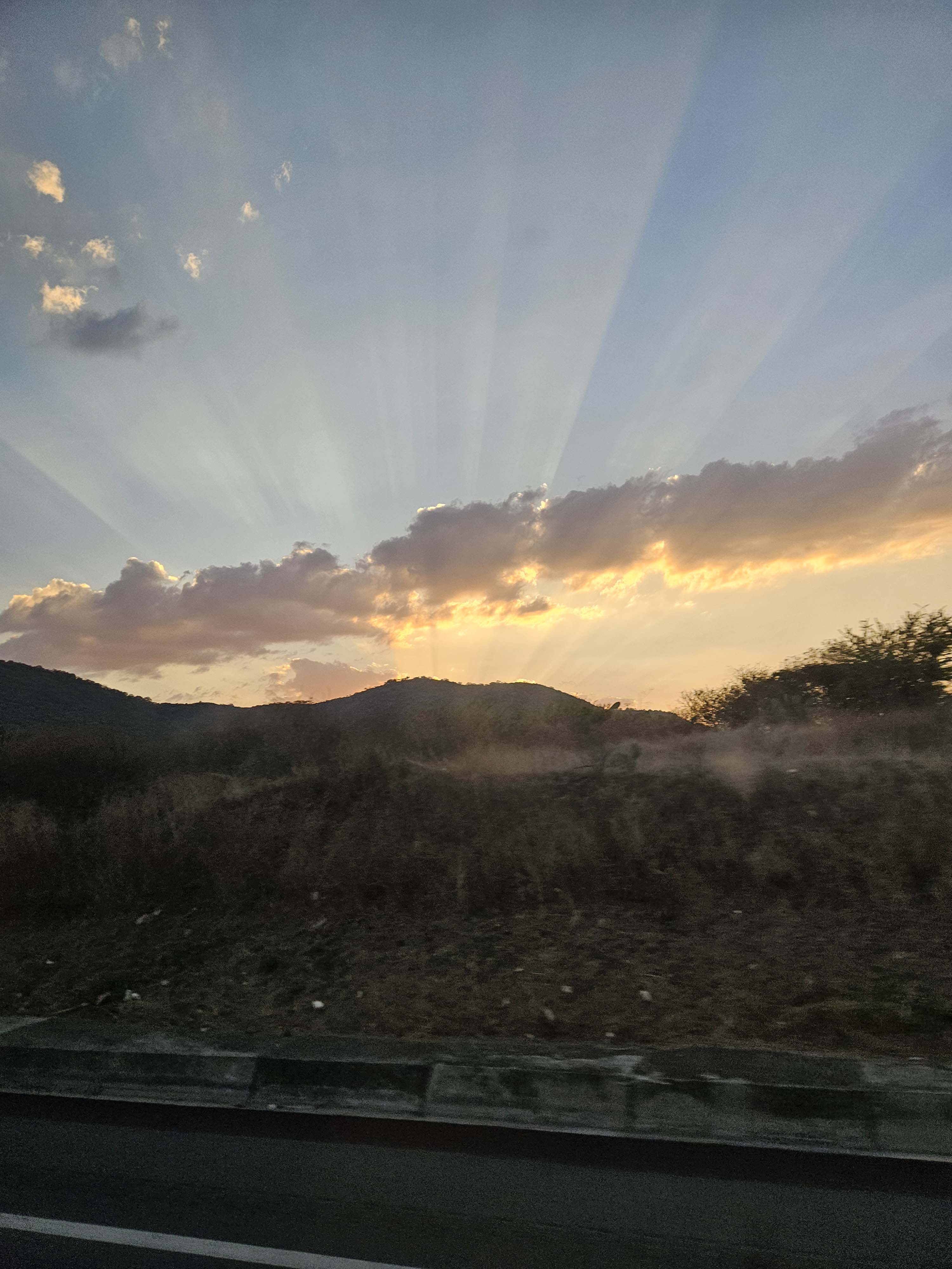 A sunrise as seen through a car window