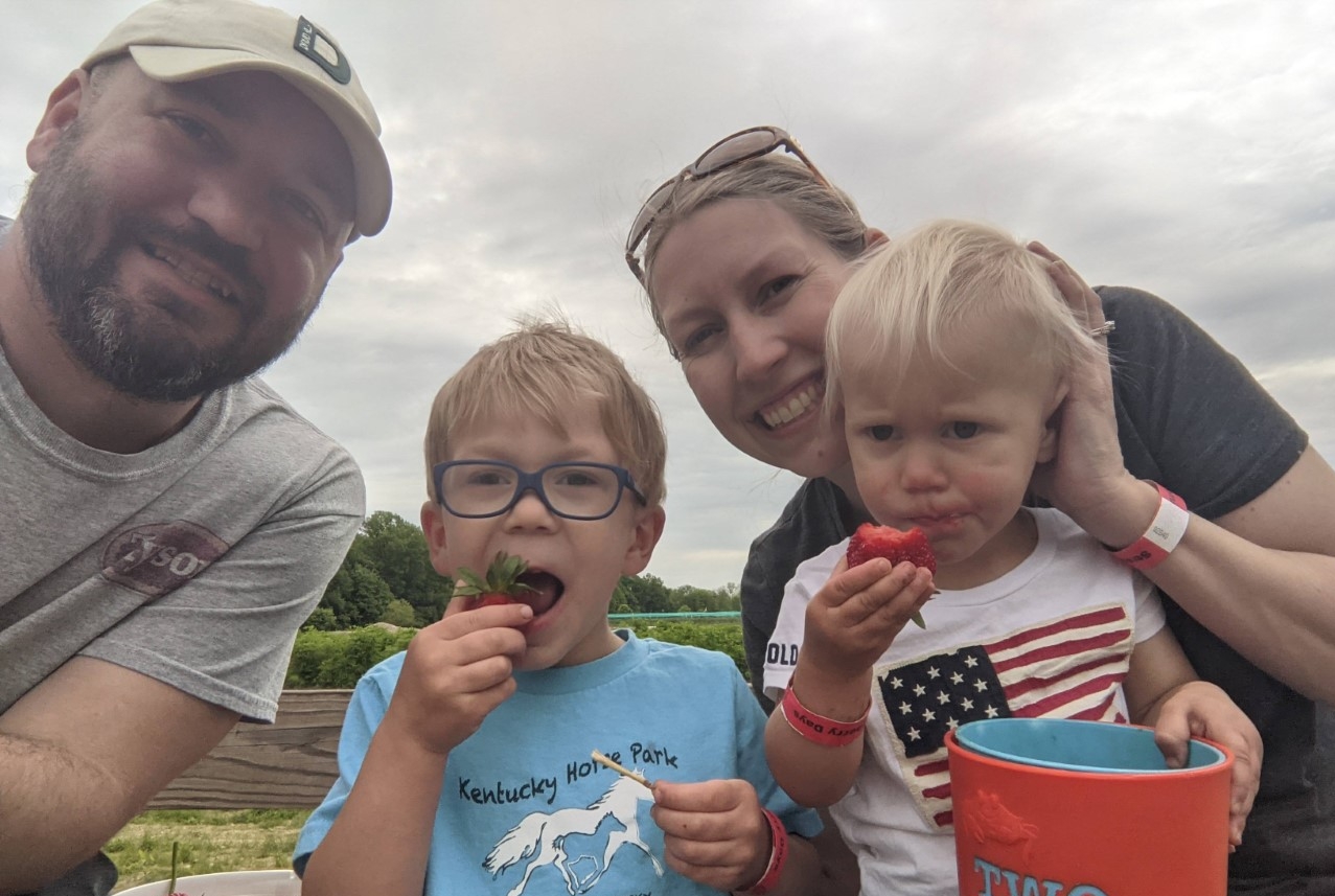 Ashley with her family eating fruit