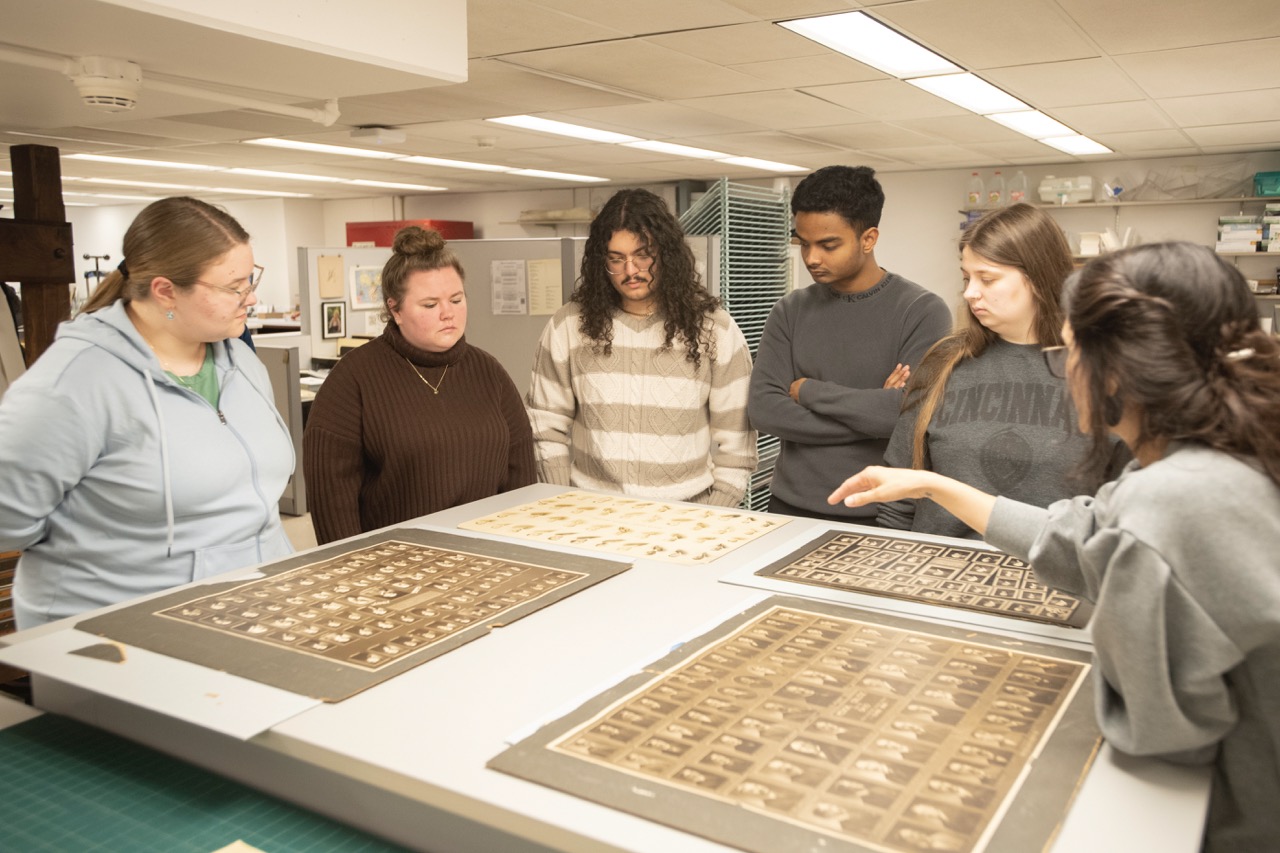 Students in class observing historic artifacts