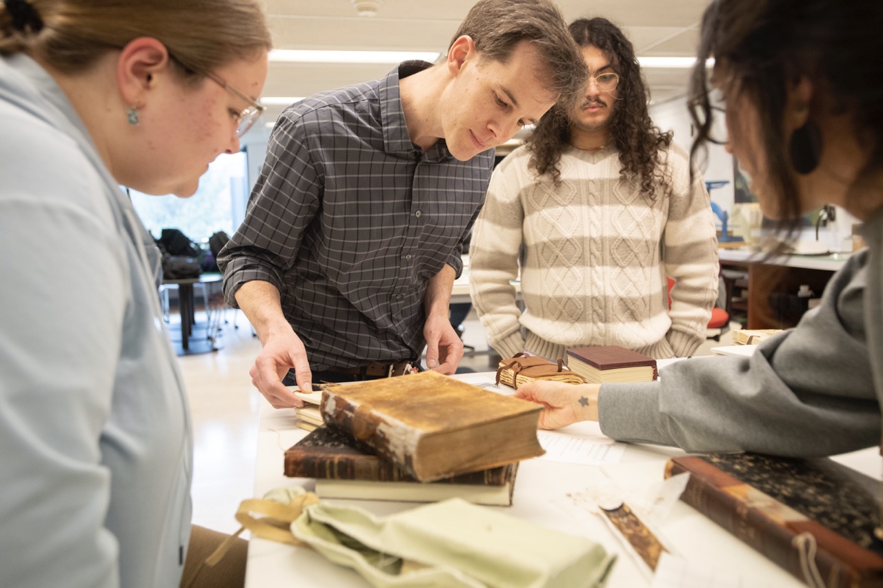 Students in class observing historic artifacts