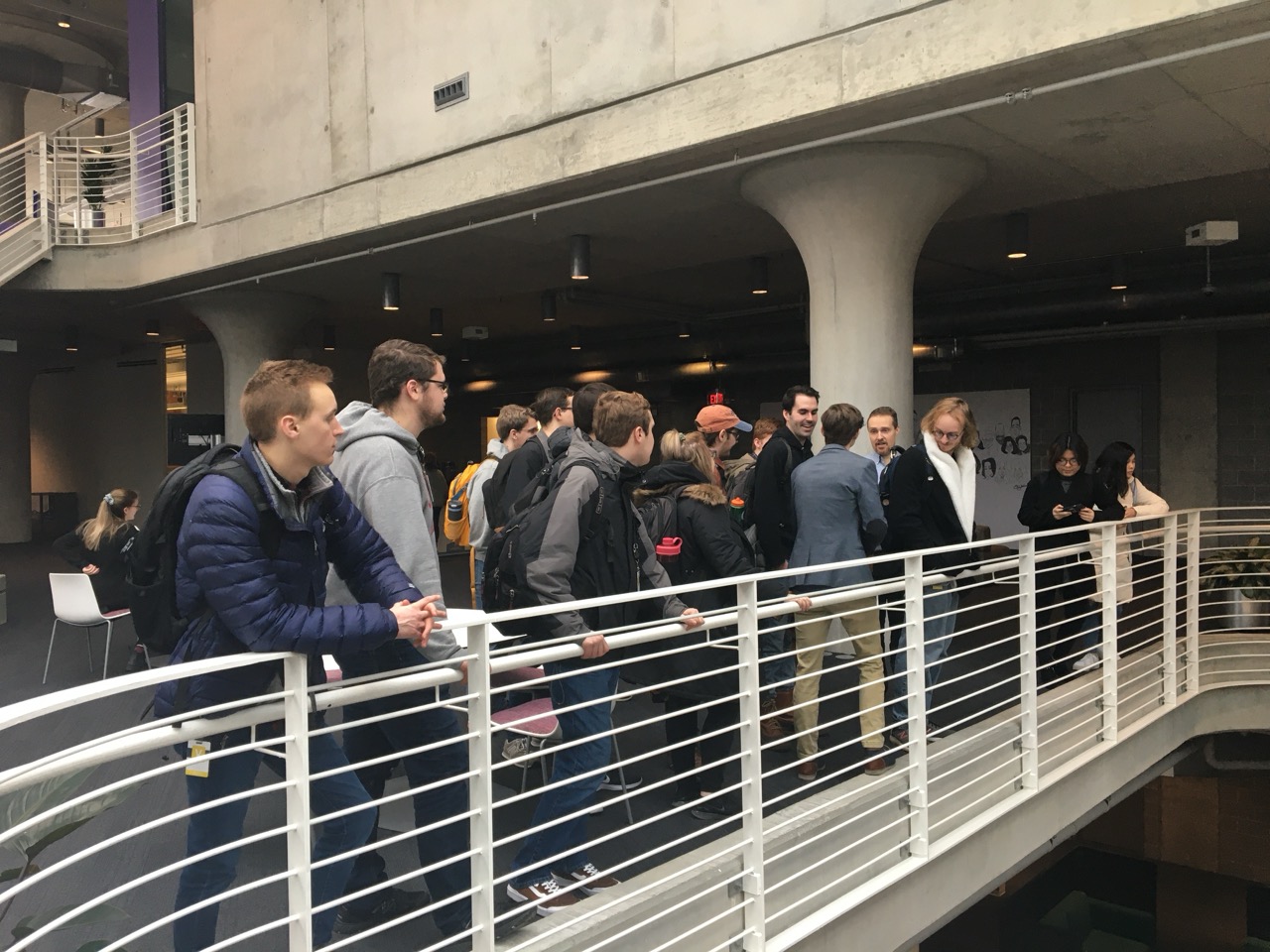 Students dress professionally walking across a bridge