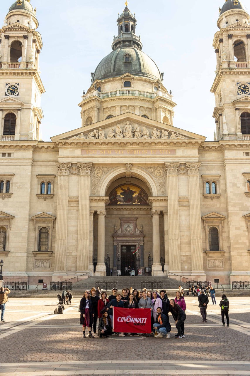 Students in Austria holding up a UC flag
