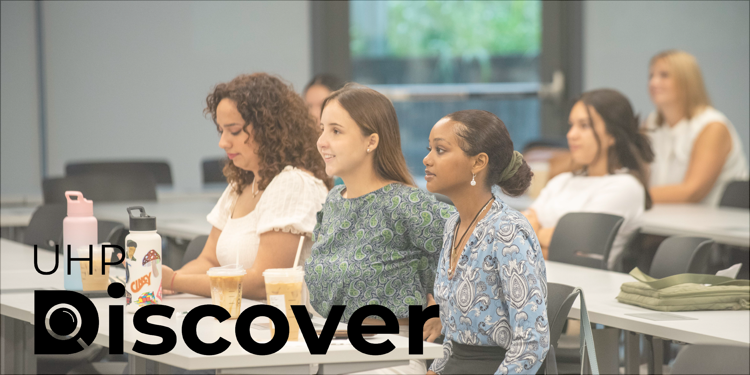 UHP Discover logo imposed over image of students in classroom