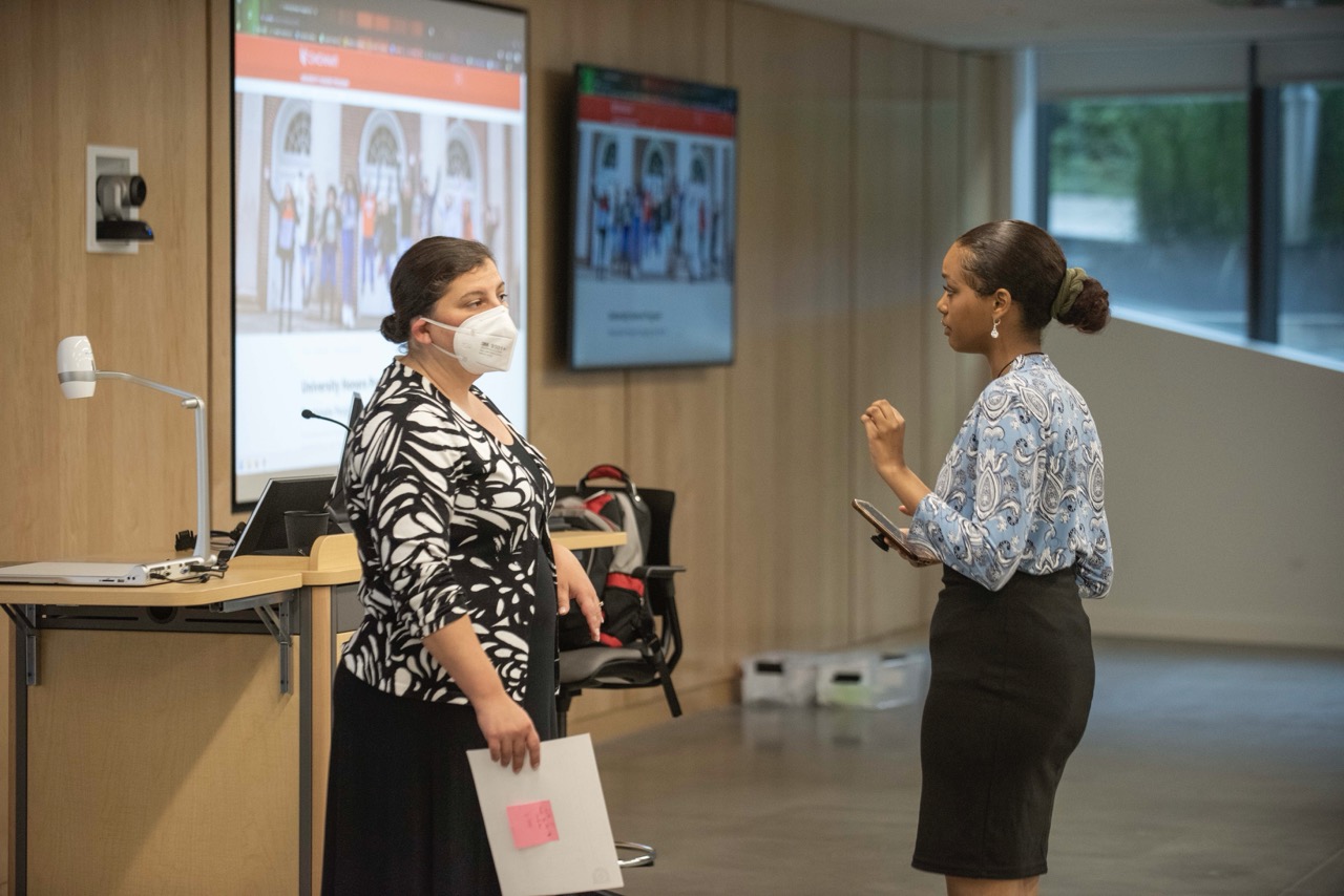 Student talking to their advisor before a presentation