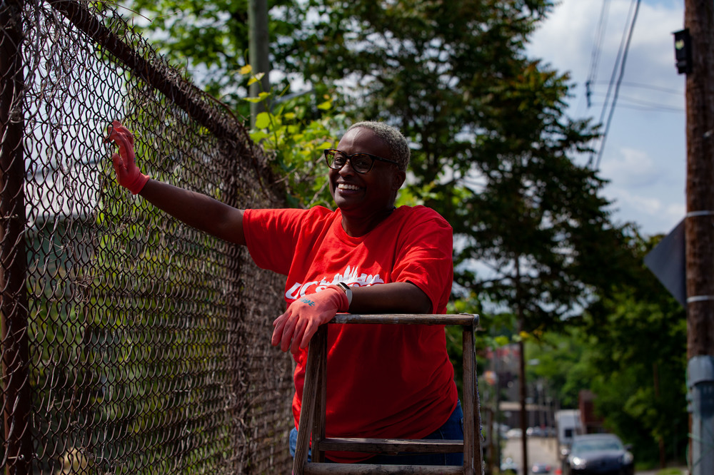 UC Employee smiles while volunteering at local garden