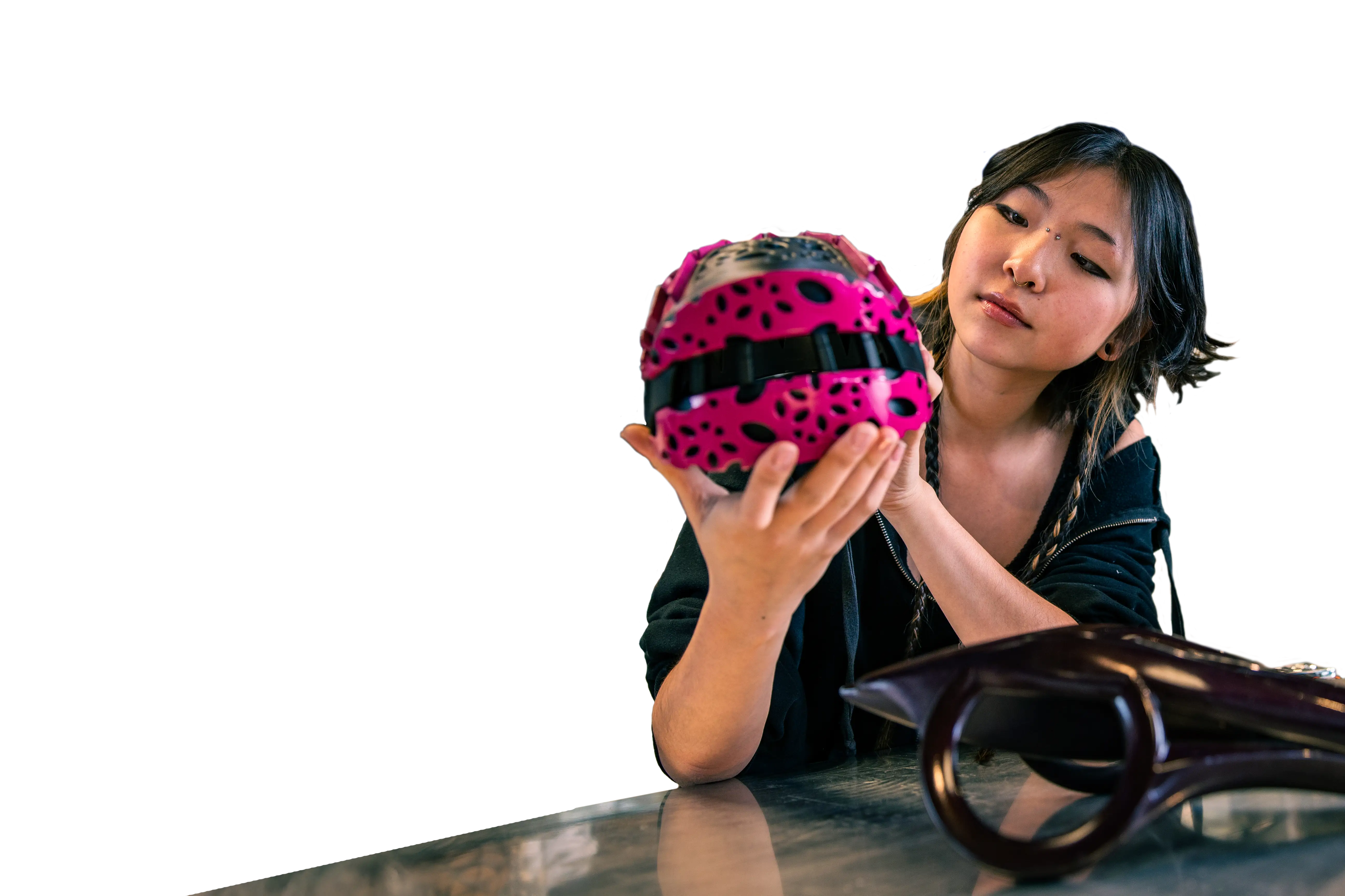 A University of Cincinnati design student inspects a 3D printed sphere