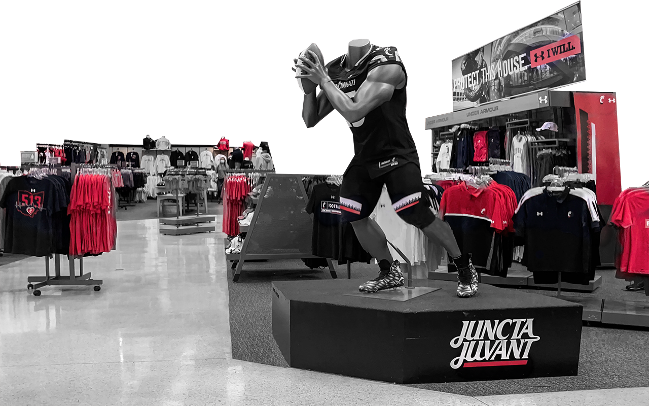Bearcats merchandise arranged in store with football mannequin in the foreground