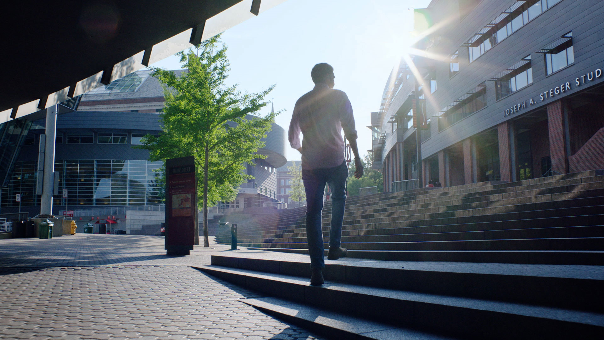 A University of Cincinnati student walks up a set of stairs on campus