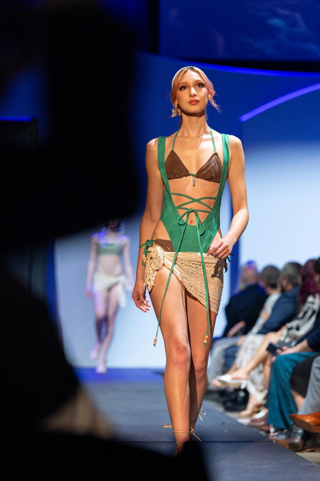 Model wearing a brown bikini top and green swiming suit over it