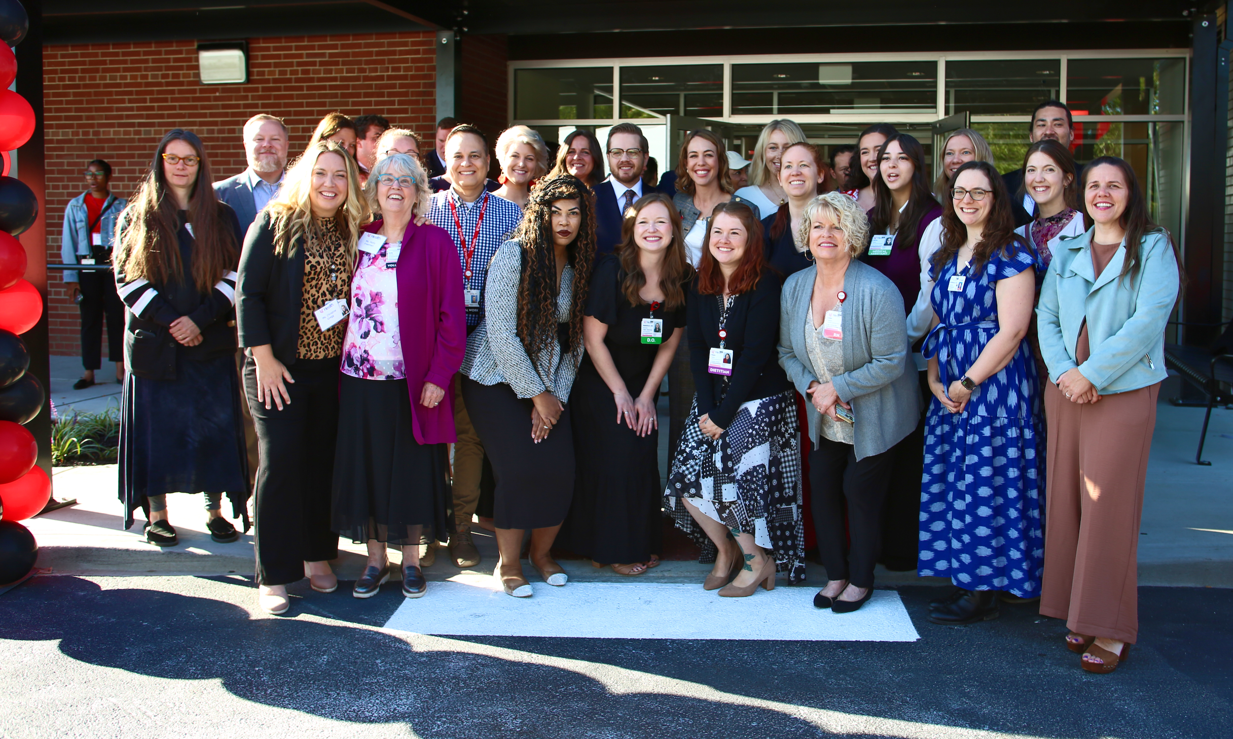 Several people stand in front of a new medical clinic.