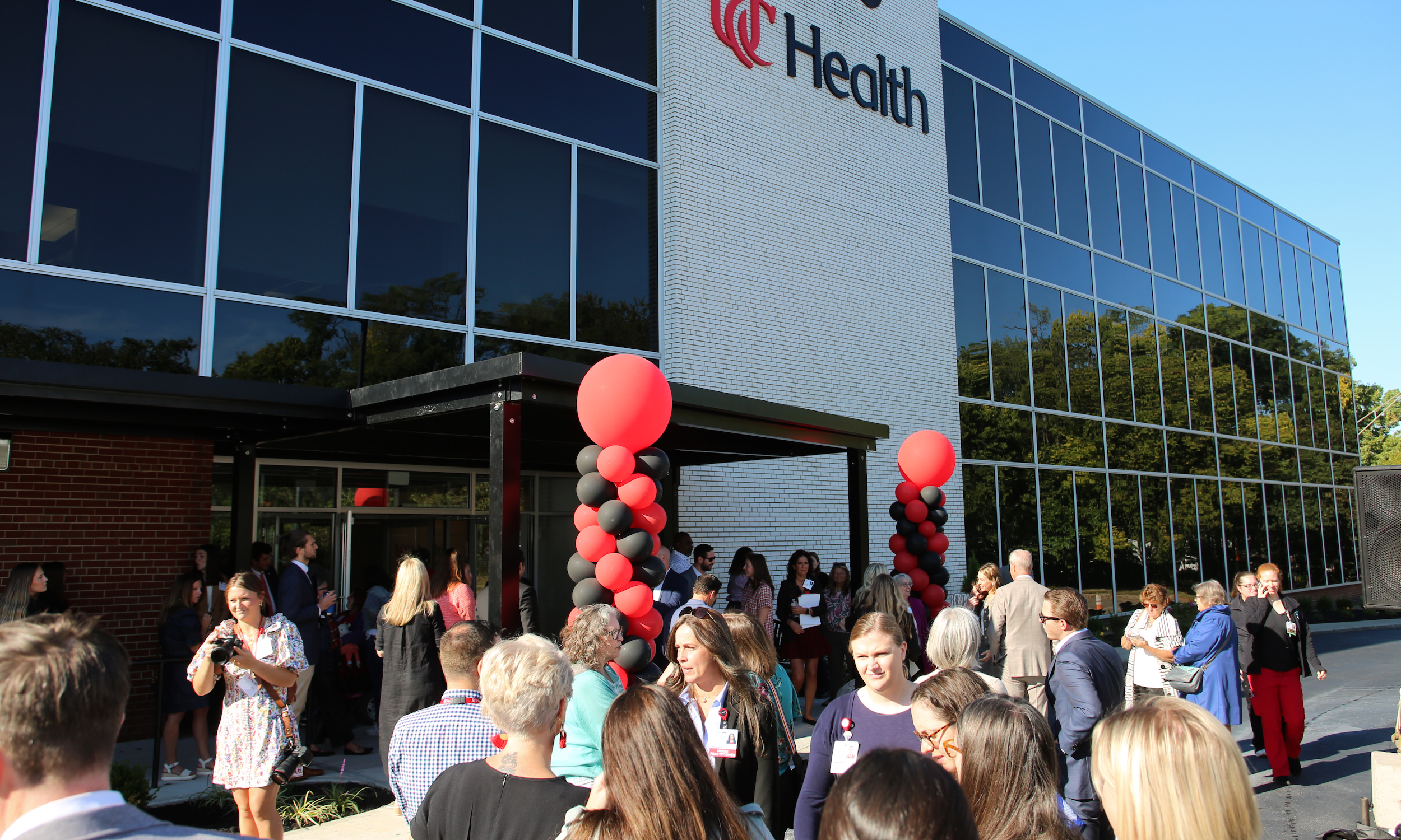 Several people stand in front of a new medical clinic.