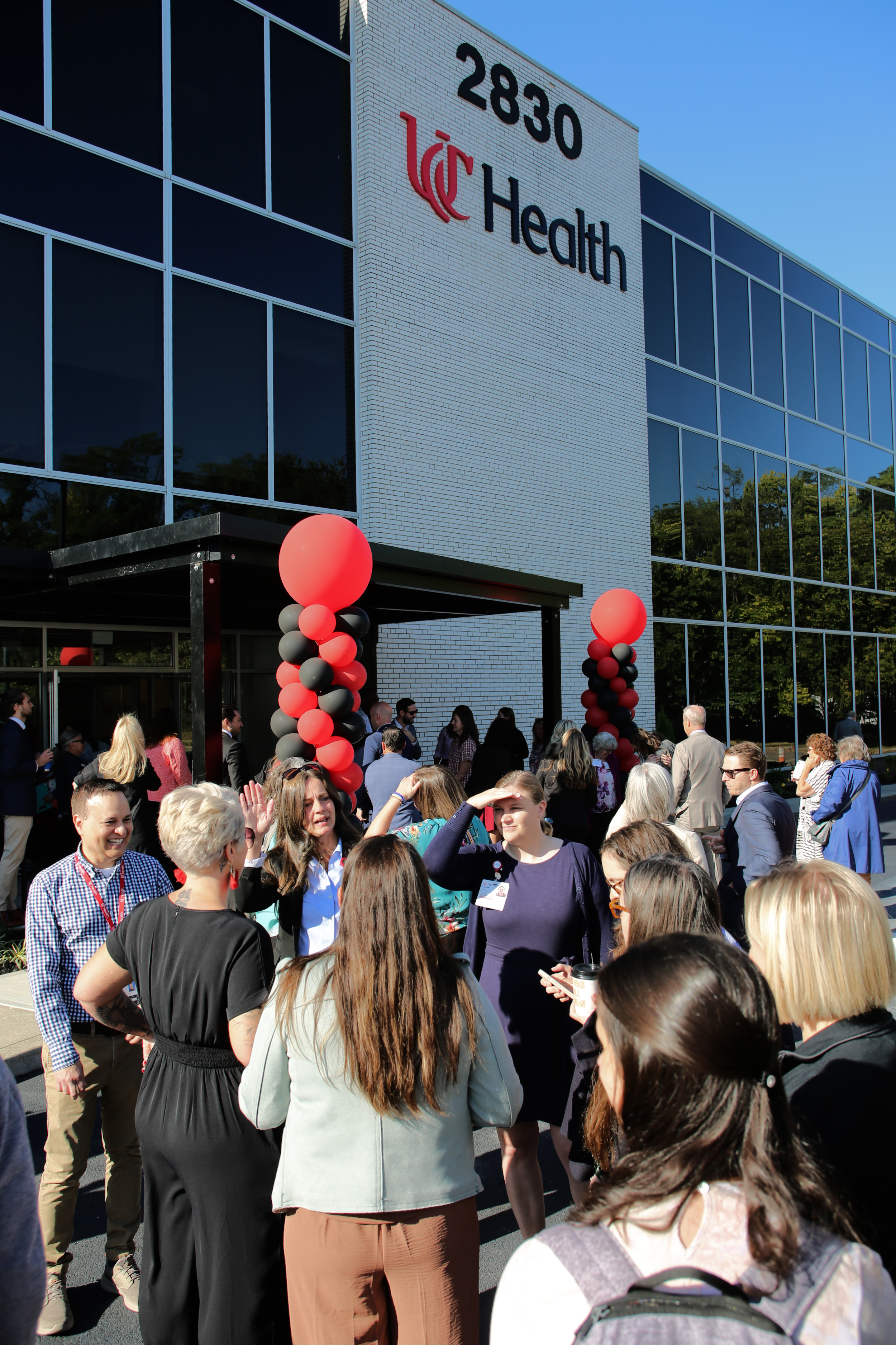 Several people stand in front of a new medical clinic.