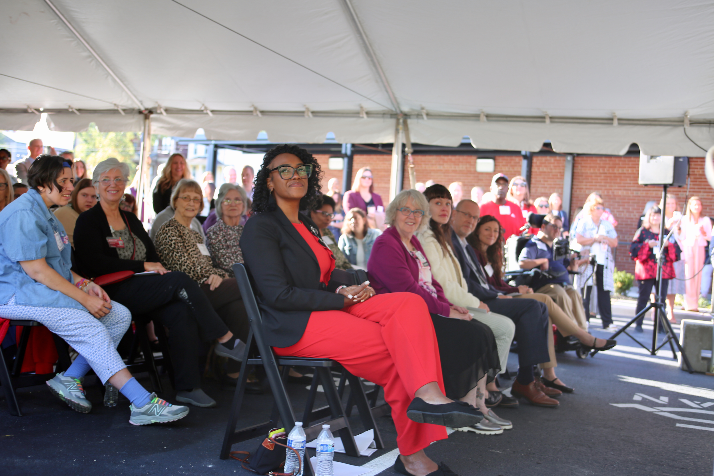 Several people stand in front of a new medical clinic.
