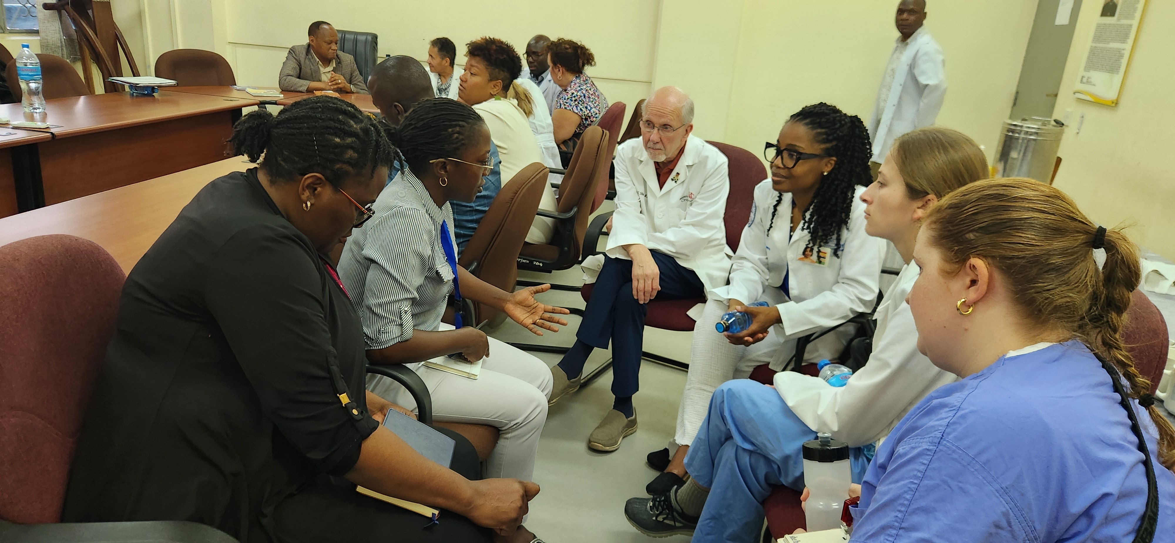 UC College of Medicine, Dean Emeritus Andy Filak, and UC med students identifying areas of collaboration between UC and Catholic University of Health and Allied Sciences. Photo/Village Life