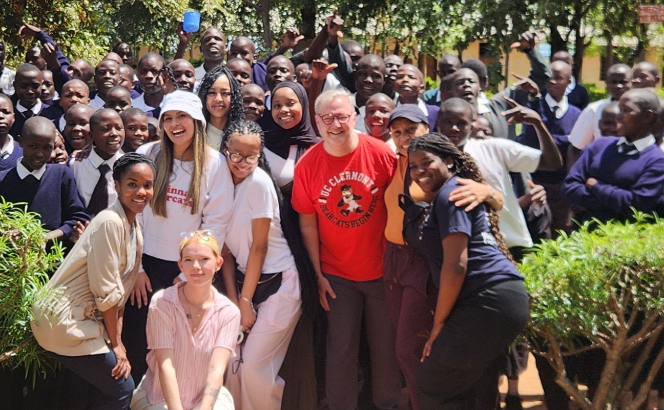 Jack Miner, UC VP Enrollment Management and Cindy Jones, Marian Spencer Scholars program director) with UCCOM 2025 grad Nkiru Ezeakudo stand with several Marian Spencer Scholars. Photo/Village Life