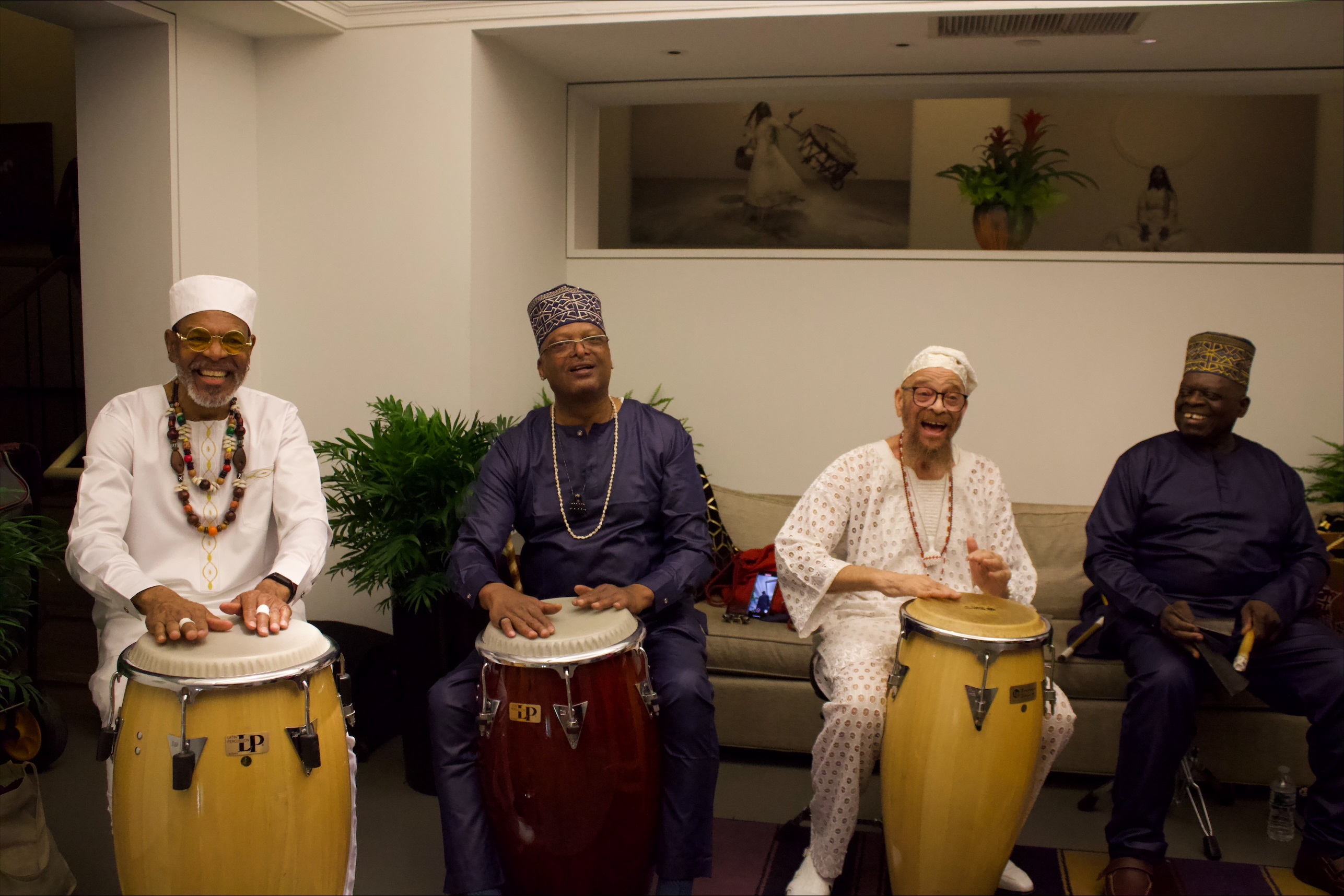 Baba Charles Miller and other master percussionists playing the drums.