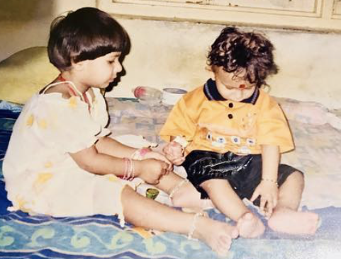 UC students Khwahish Singh and Kartavya Singh as sitting on the floor together in a home in India