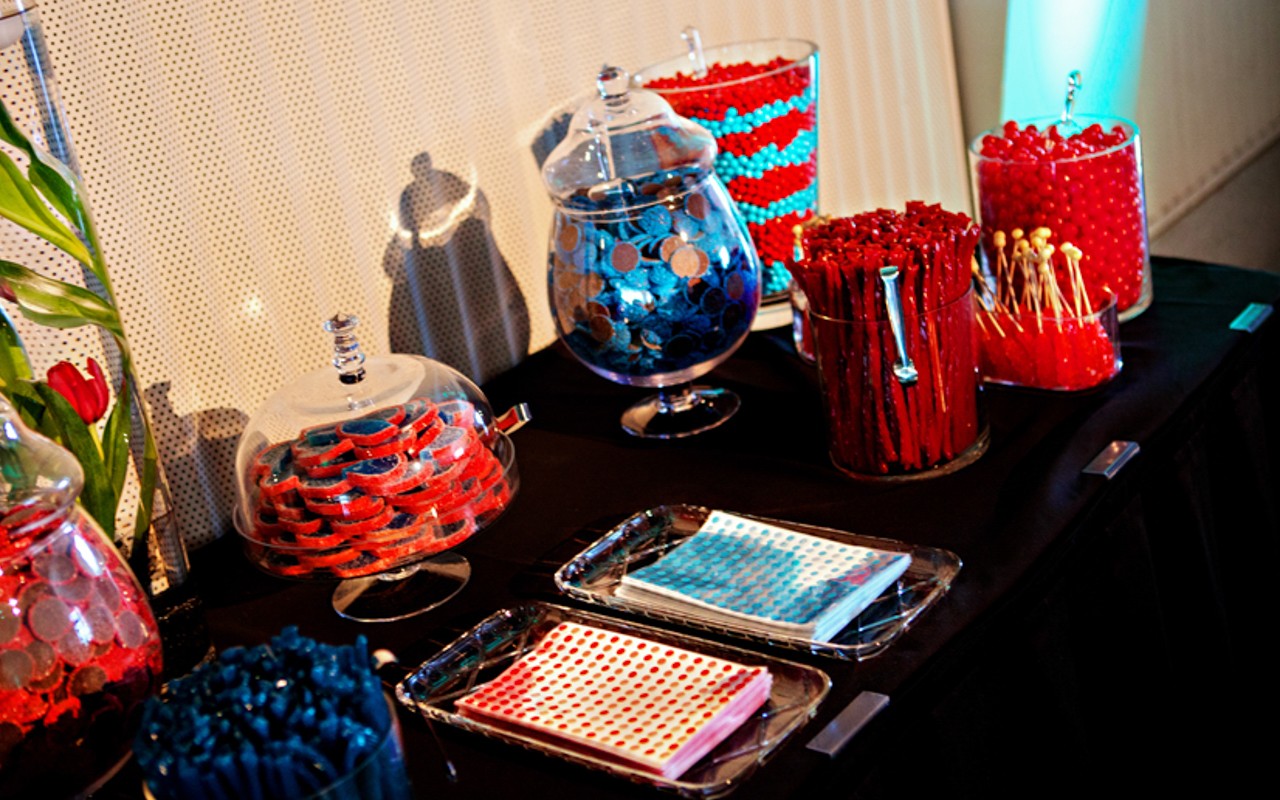 Containers of candy decorate a table for wedding favors.