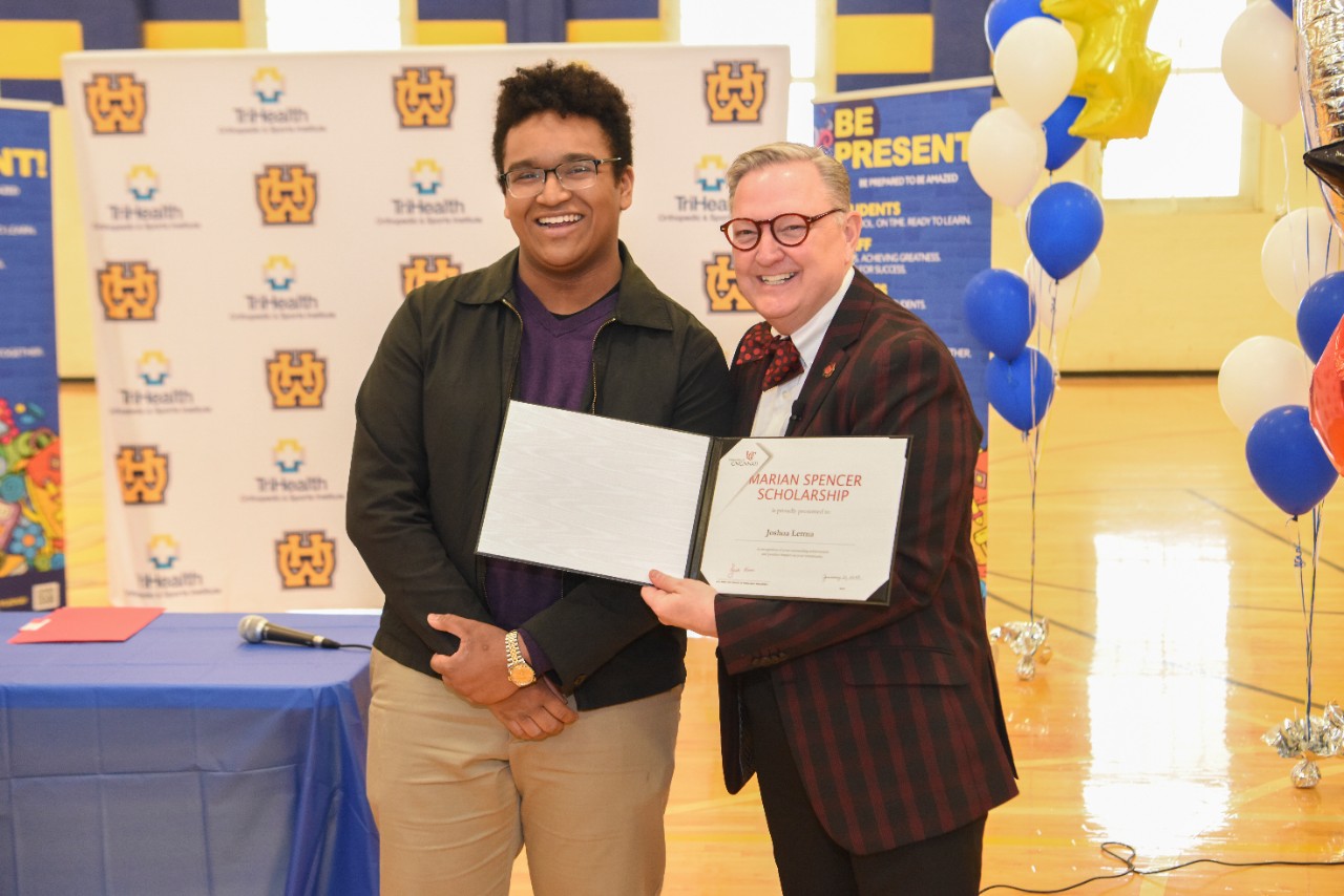Jack Miner, Vice Provost for Enrollment Management surprised Joshua Lerma future UC Bearcats with Marian Spencer Scholarship awards at Walnut Hills High School Tuesday January 31, 2023. Marian Spencer Scholarship  award students with full tuition, room and board and an all-expenses-paid study abroad experience from the University of Cincinnati. Photos by Joseph Fuqua II