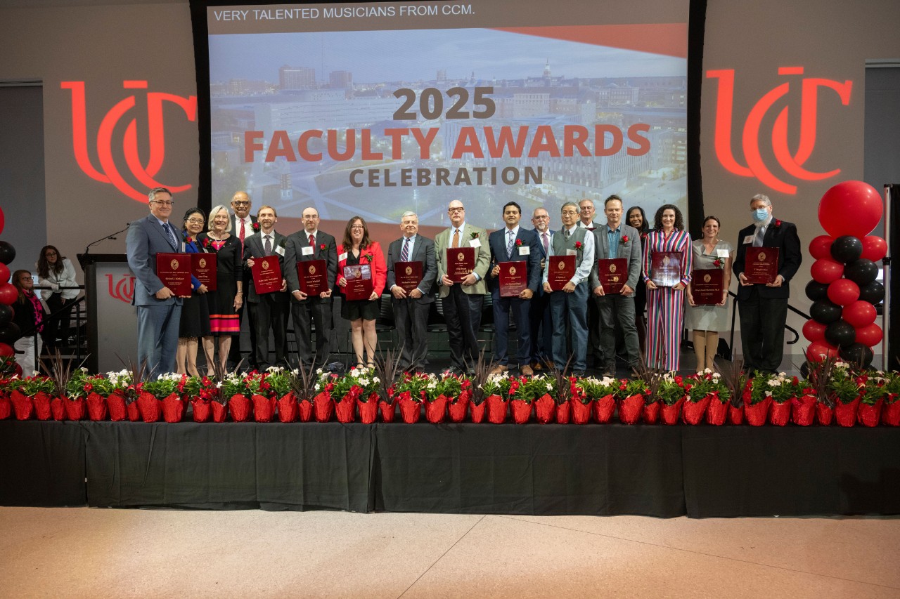 faculty award winners standing in a group on stage