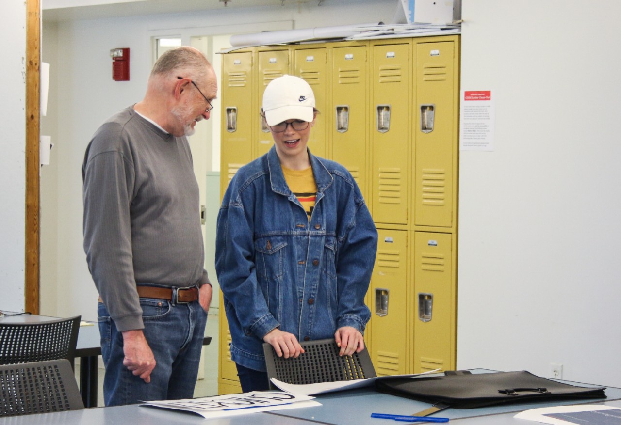 DAAP faculty talking with student