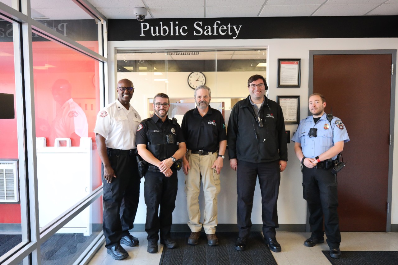 From left, a fire inspector, a police officer, a access technician, a communications dispatcher and a security officer stand in the Public Safety lobby.