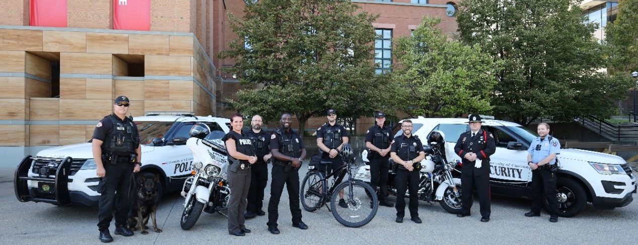 Five police officers and a security officer pose on campus.