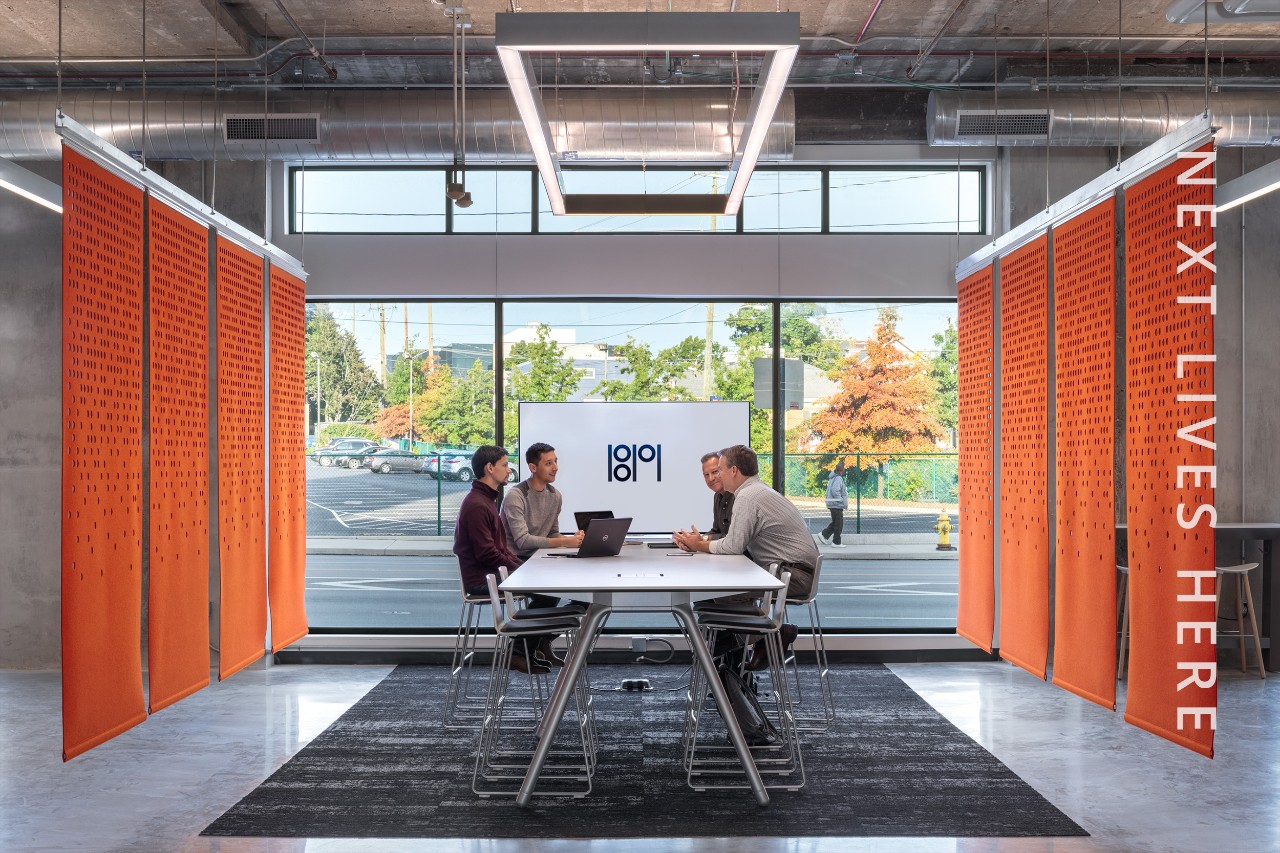 group of 1819 employees sitting at a table collaborating 