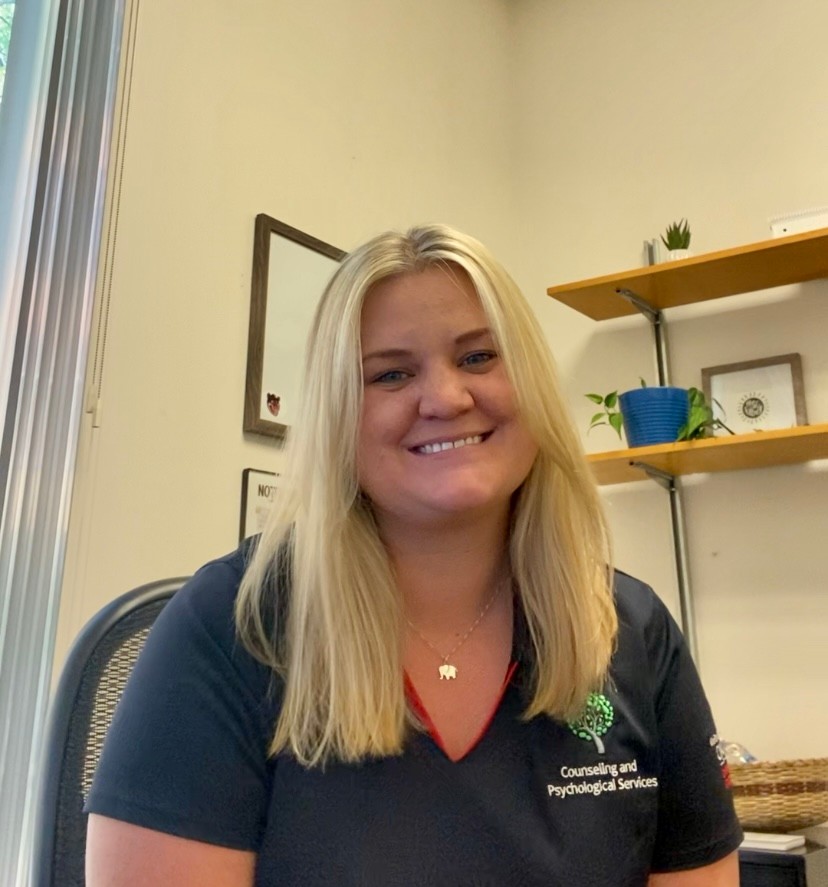 Caity sitting in her office. 