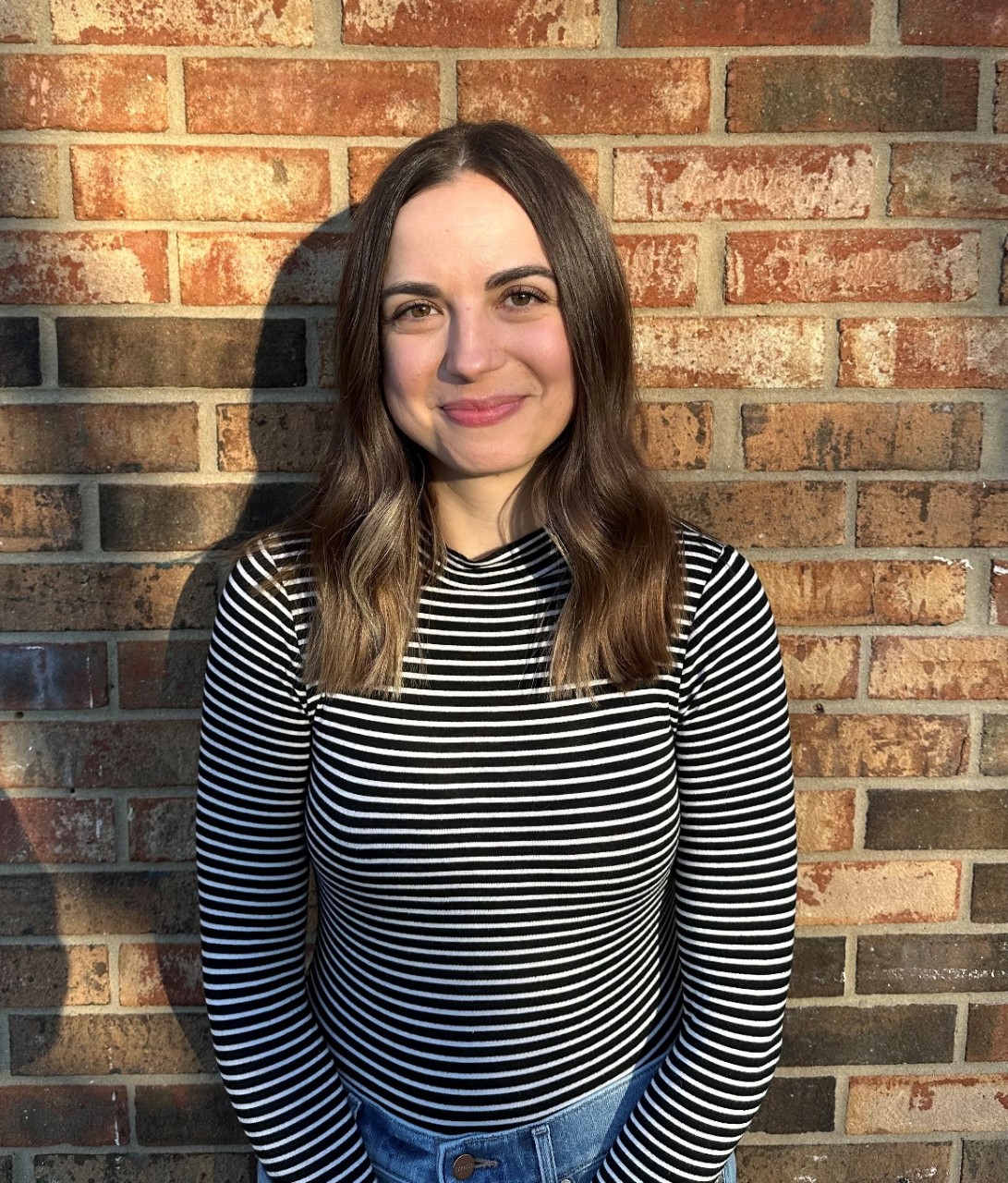 Hannah smiling outside.