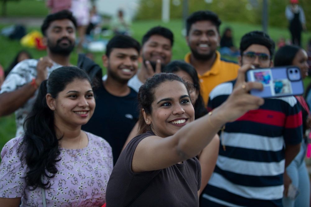 group of young people posing for a selfie