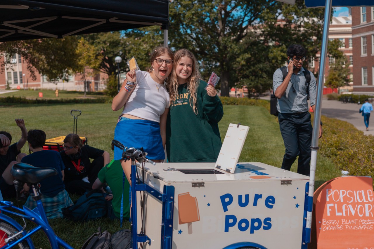 Students at a PAC event in fall 2023, "Pops & Pups", eating popsicles