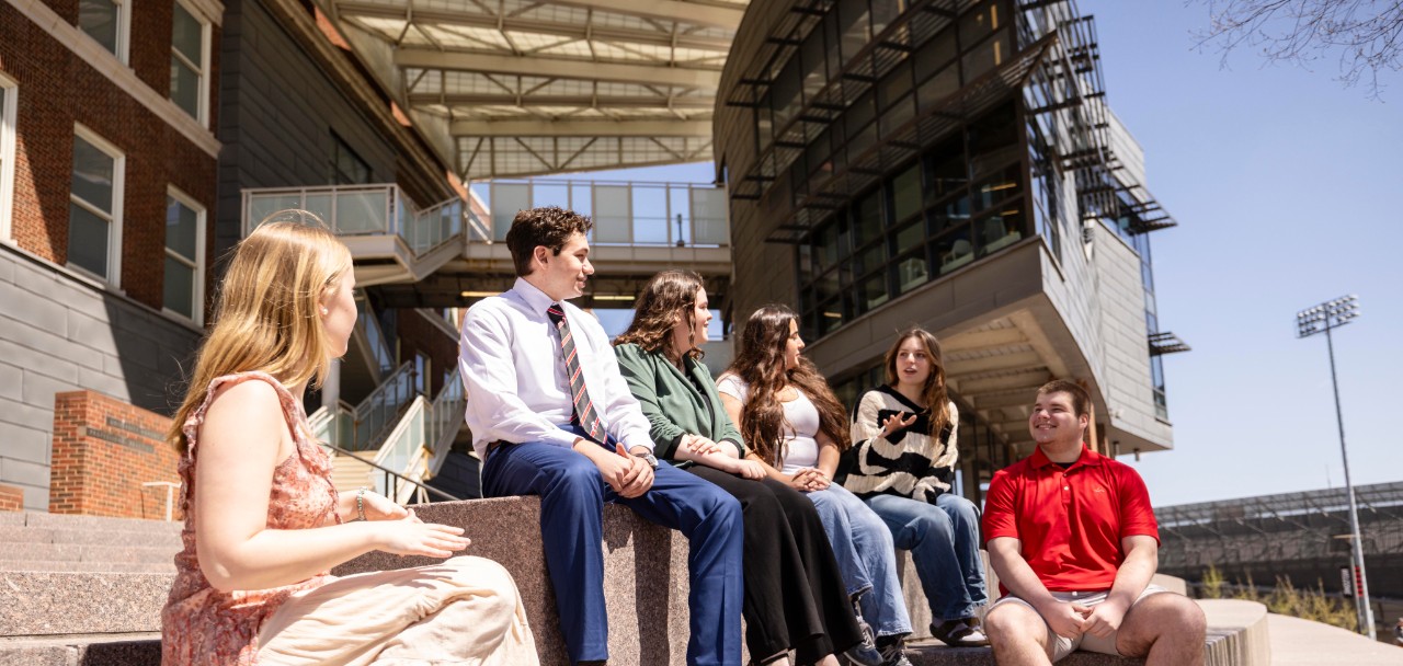 Hoffman students sit together outside Swift Hall