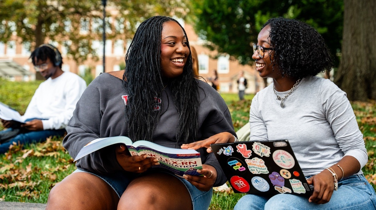 Two students studying outside of Arts and Sciences