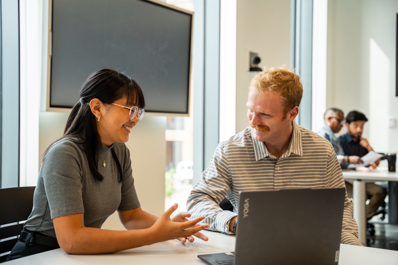 Two students in a classroom collaborating