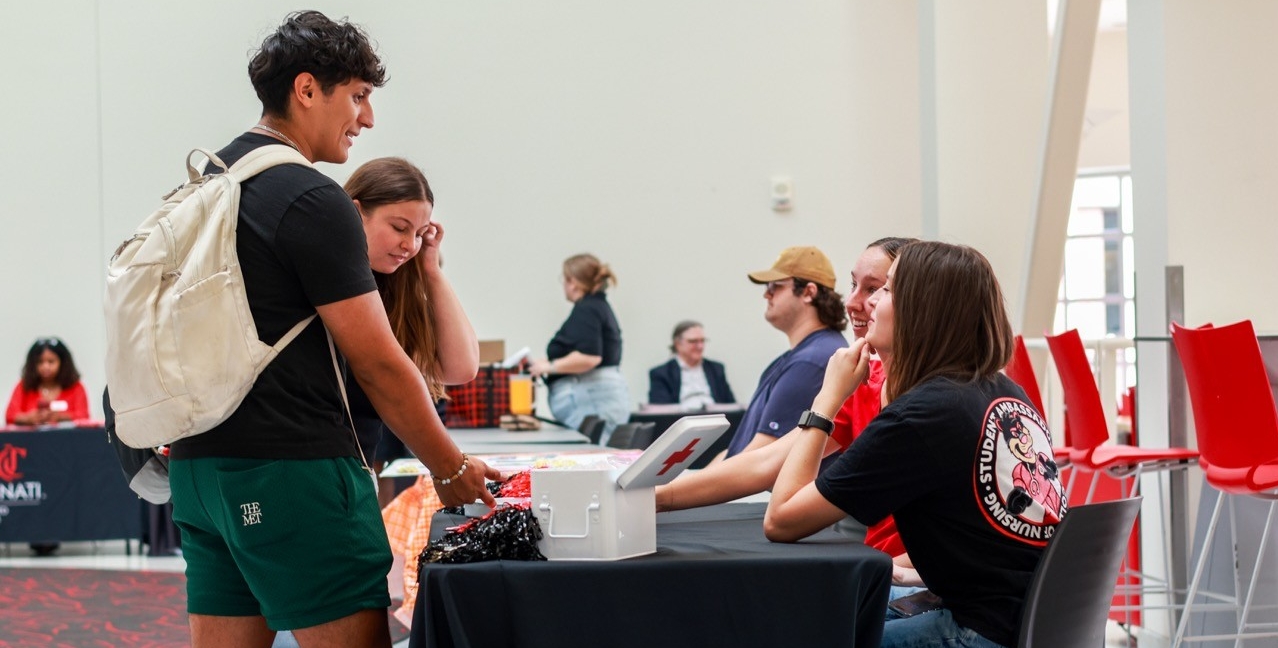 Students talking to other students at a booth in TUC