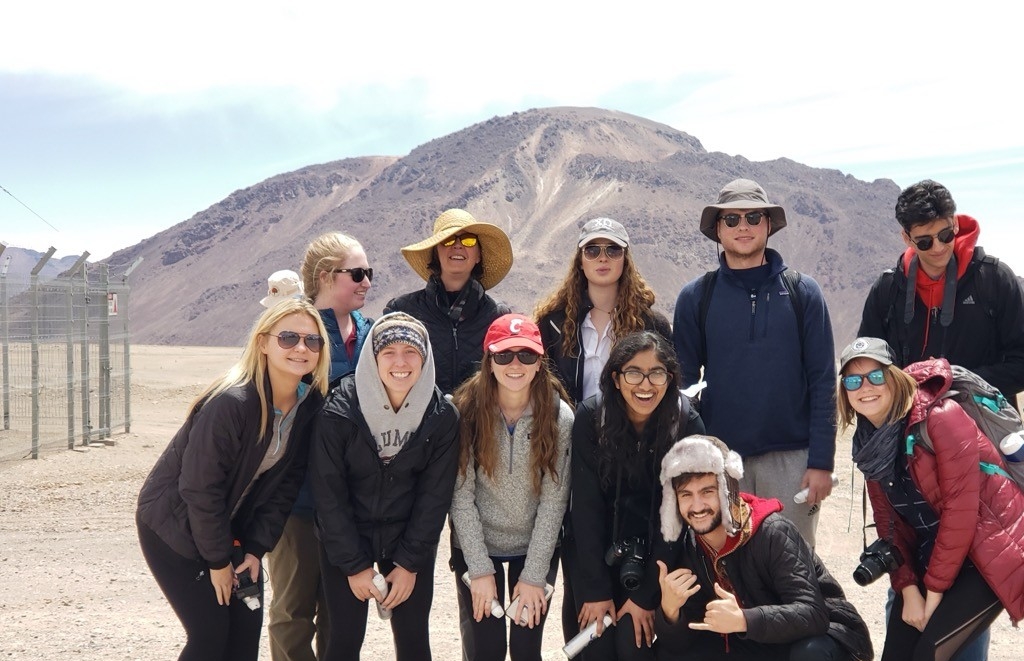 Students pose for a picture by the water in Iceland.
