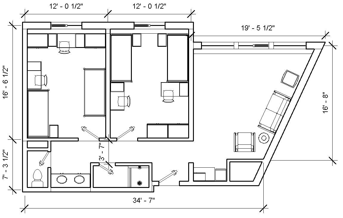 Turner Hall double with 2 bedrooms, each with 2 beds, desks and closets, and a common bathroom and common area with a sofa and chair