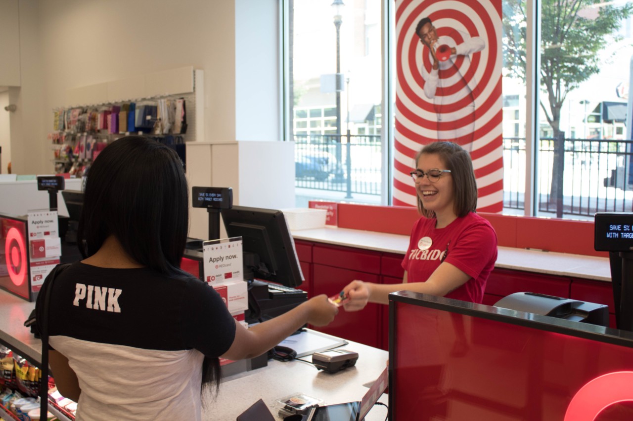 Young African-American woman purchases something at Target.