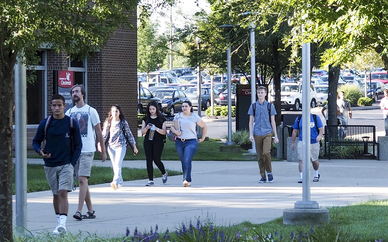 Students walk along a sidewalk at UC Clermont