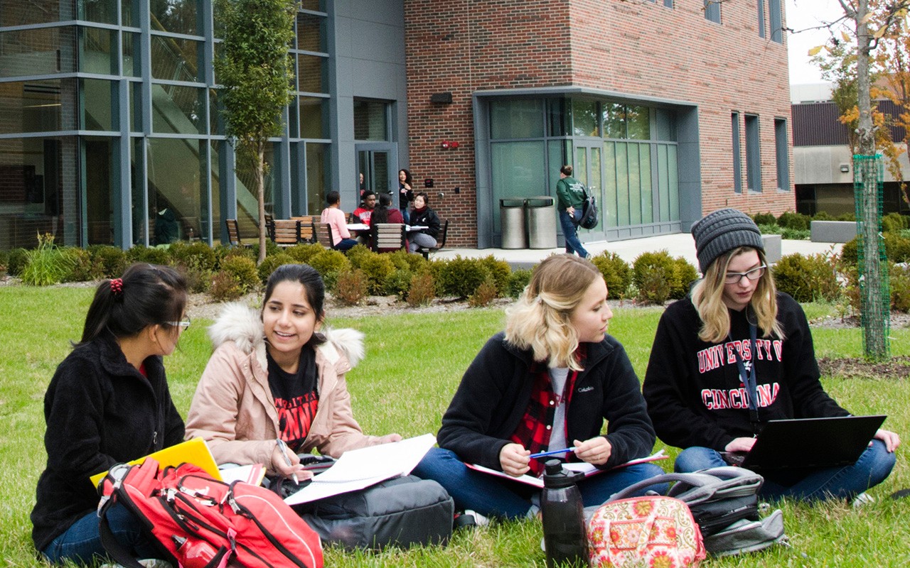 Students seated on the lawn on the Blue Ash campus