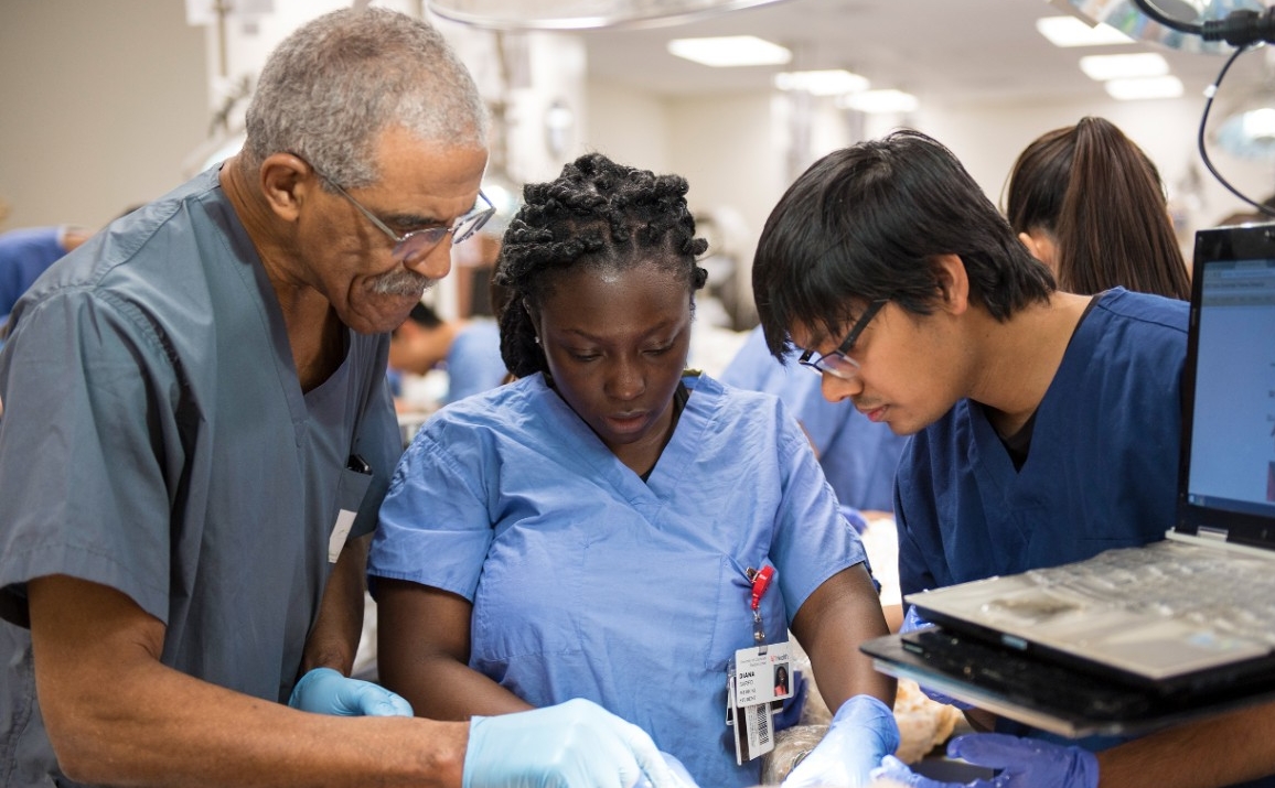 UC students work with a professor in a medical lab