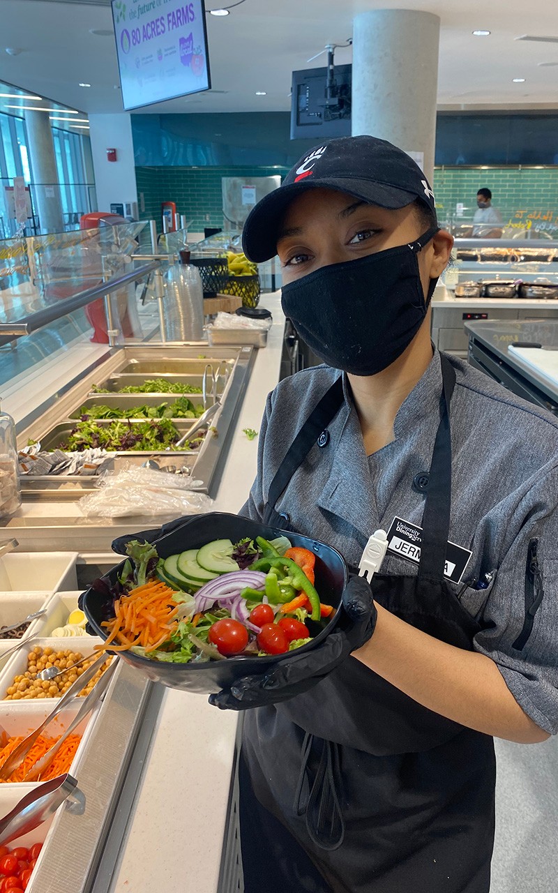 Woman holding a salad in the dining hall