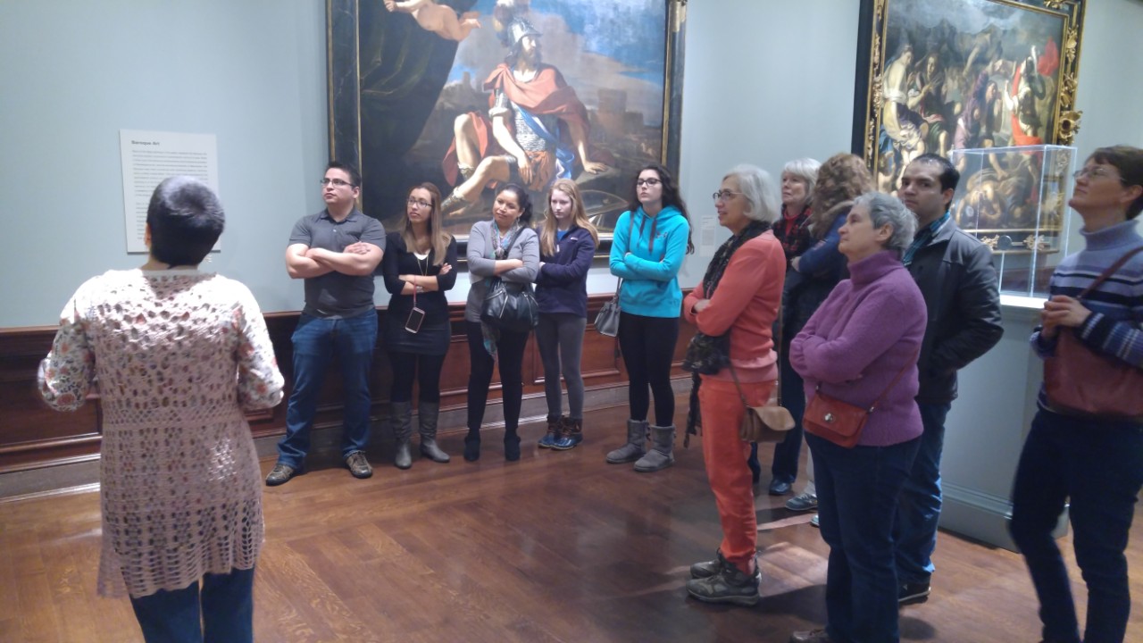 group of adults in the Cincinnati Art Museum looking at art work on a wall