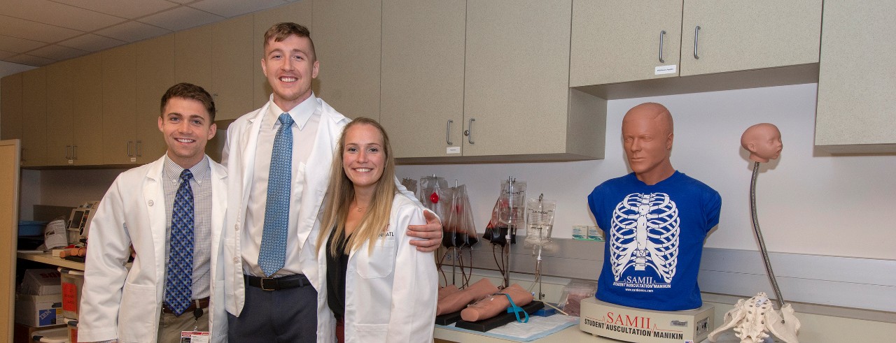L to R Andrew, John and Kensie used first responder techniques learned at COM  to rescue a person who collapsed outside of the medical campus.