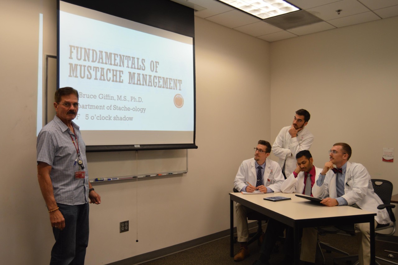 Bruce Giffin, PhD,  shown with UC medical students posing for Mustaches in Medicine calendar.